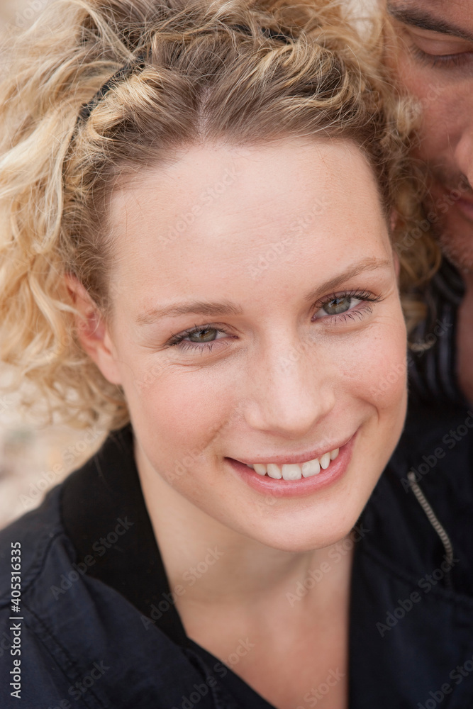 couple embracing smiling at viewer couple embracing smiling at viewer