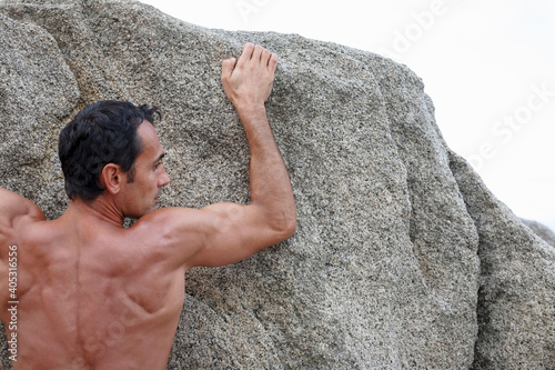 Man scaling steep rock face