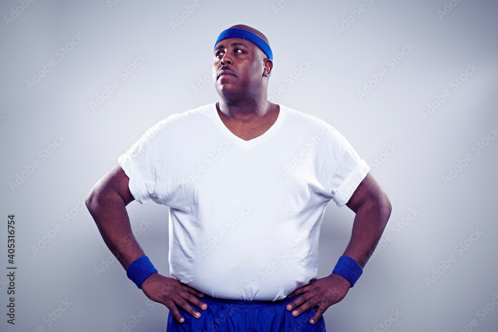Mature man wearing white t shirt, hands on hips