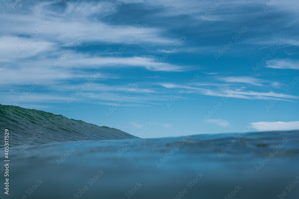 Breaking Waves and spray, white water and light reflected on the surface of the water