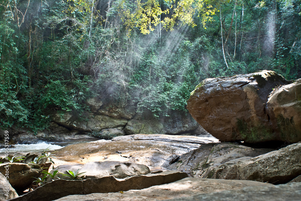 Waterfall and rocks in shafts of sunlight, Chiang Mai, Thailand