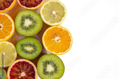 set of fruits with vitamin c, kiwi, lelon, red orange, yellow orange in a cut isolate on white