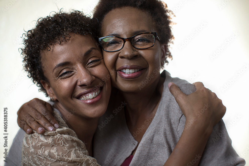 Studio portrait of two mature women smiling and hugging Studio portrait of two mature women smiling and hugging