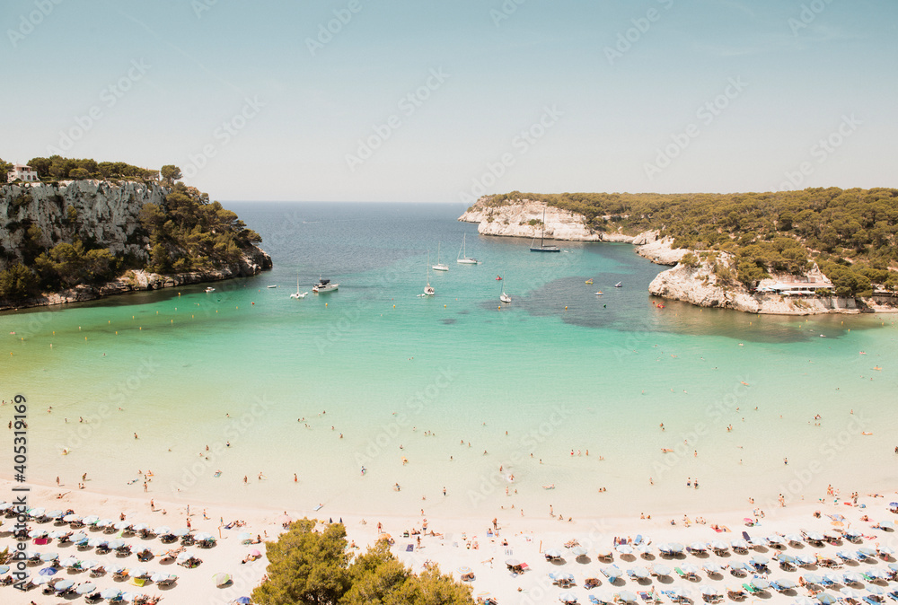 High angle view of tourists and rows of sunloungers on beach, Cala Galdana, Menorca, Balearic Islands, Spain High angle view of tourists and rows of sunloungers on beach, Cala Galdana, Menorca, Balearic Islands, Spain