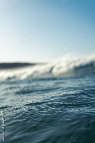 Breaking Waves and spray, white water and light reflected on the surface of the water