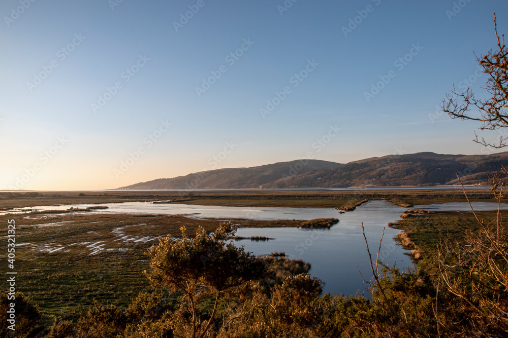 the marsh land of ynys-hir nature reserve with the mountains behind aberdyfi in the background