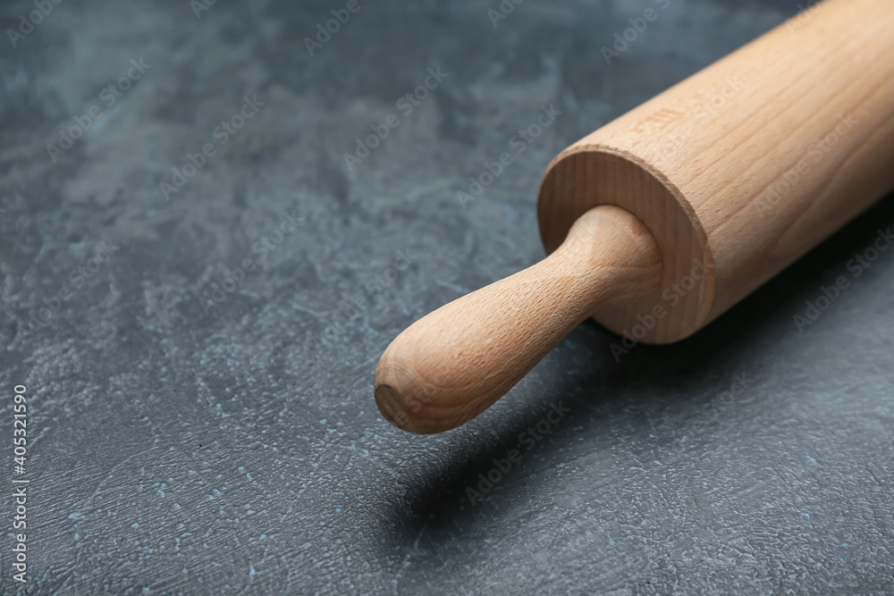 Wooden rolling pin on dark background