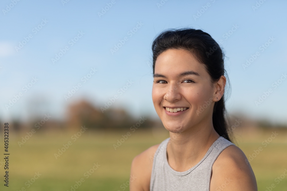 close up portrait of Vietnamese-American woman smiling with park background 0305 close up portrait of Vietnamese-American woman smiling with park background 0305