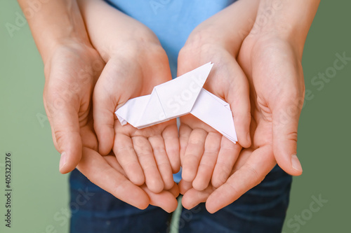 Hands of family with paper ...