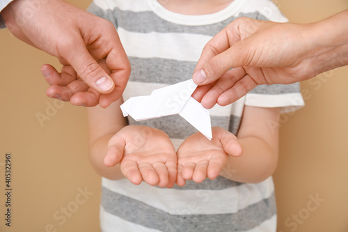 Hands of family with paper ...