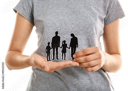 Woman holding human figures...