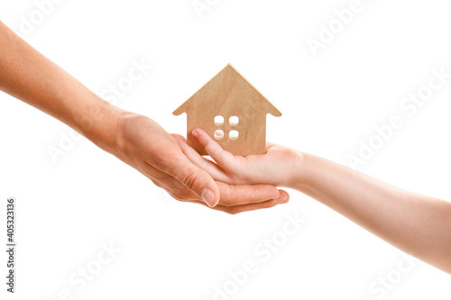 Hands of family with figure of wooden house isolated on white background