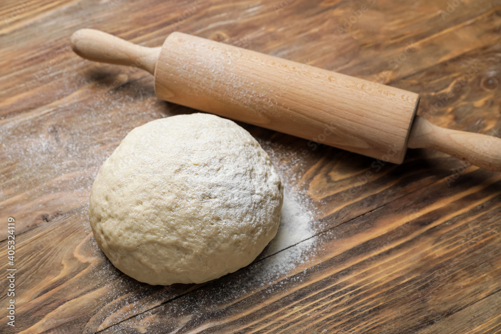 Fresh dough and rolling pin on wooden background Fresh dough and rolling pin on wooden background