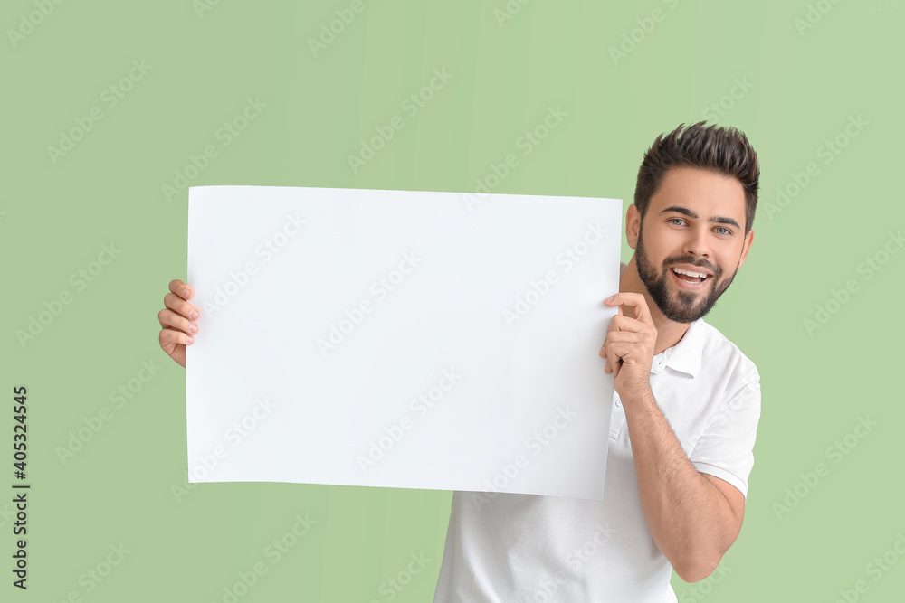 Young man with blank paper sheet on color background Young man with blank paper sheet on color background