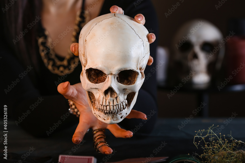 Fortune teller with human skull at table Fortune teller with human skull at table