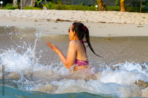 Fototapeta Naklejka Na Ścianę i Meble -  Woman pretty in bikini happy on water at beach