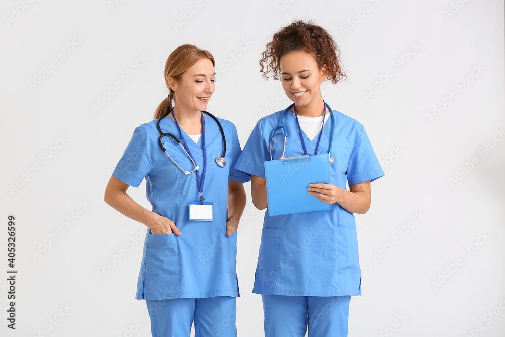 Portrait of female doctors on light background Portrait of female doctors on light background