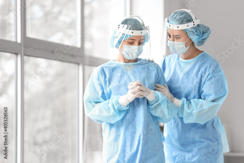 Female surgeon calming her colleague after operation in clinic