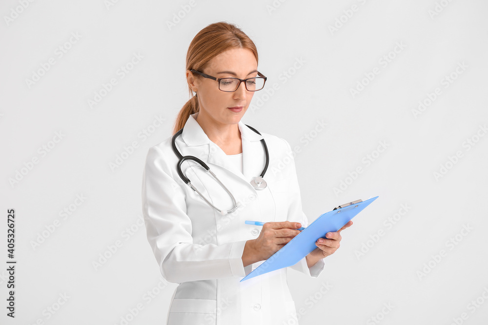 Portrait of female doctor on light background Portrait of female doctor on light background