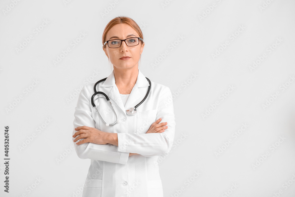 Portrait of female doctor on light background Portrait of female doctor on light background