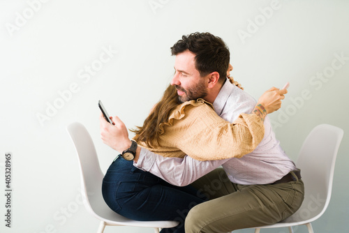 Latin couple chatting online are thinking of hugging each other