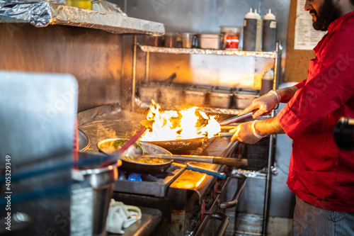 Fotografie Chef preparing cooking and serving indian cuisine dish