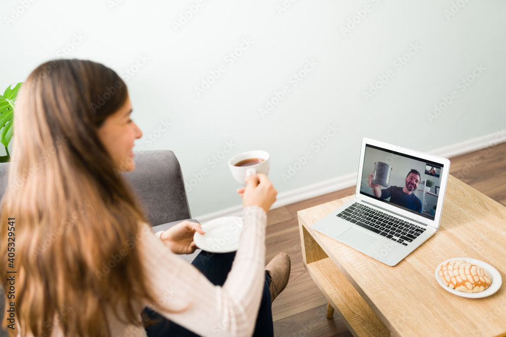 Rear view of a wife having a date with her husband in a videochat Rear view of a wife having a date with her husband in a videochat