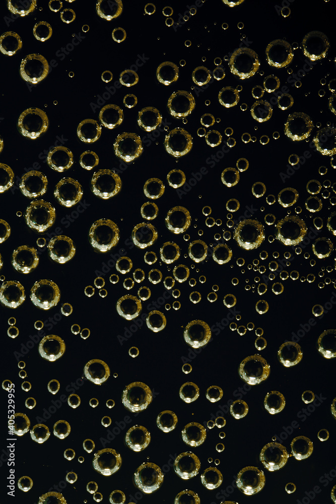 Golden air bubbles on a flat surface