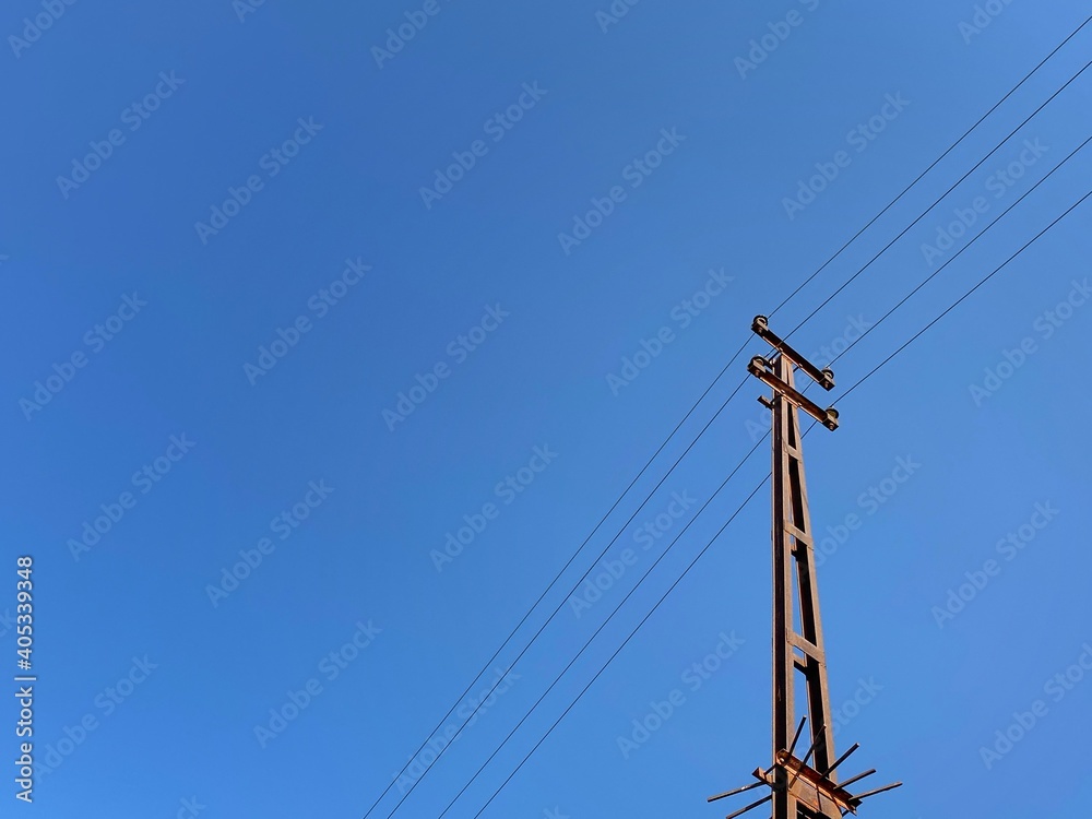 Electricity transmission tower with wires and blue sky background Electricity transmission tower with wires and blue sky background