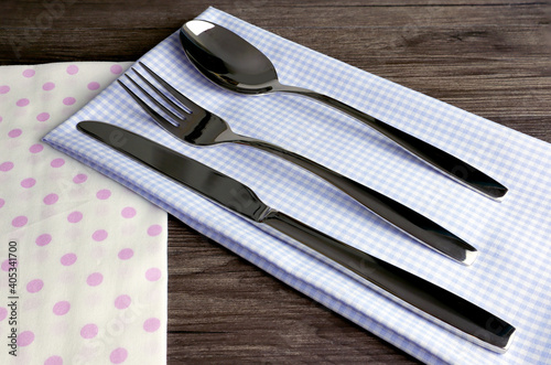 Silverware or flatware set of fork, spoon and knife on wooden table.