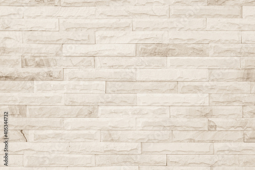 Empty background of wide cream brick wall texture. Beige old brown brick wall concrete or stone textured  wallpaper limestone abstract flooring Grid uneven interior rock. Home decor design backdrop.