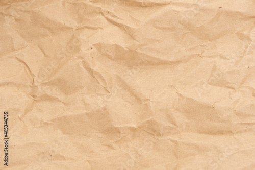 Crumpled brown paper texture perfect for background structure. Packaging material with rough wrinkles. The grunge textured surface is a vintage backdrop.