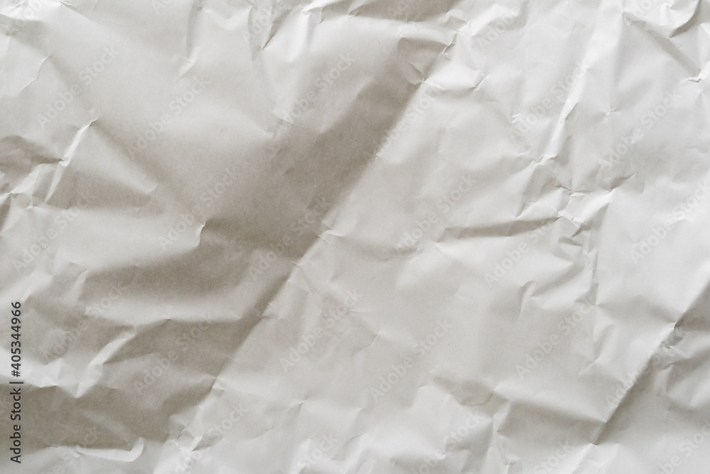 Fototapeta premium Crumpled white paper texture perfect for background structure. Packaging material with rough wrinkles. The grunge textured surface is a vintage backdrop.