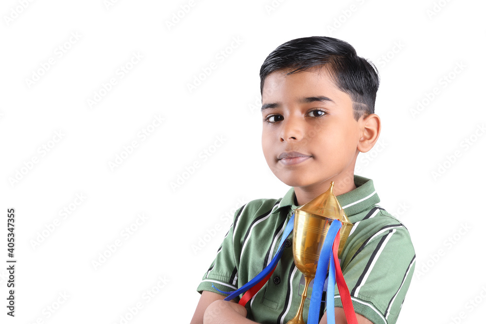 Indian school boy holding a golden trophy cup Indian school boy holding a golden trophy cup