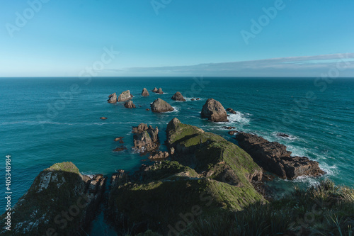 Nugget point during morning daylight on the blue ocean. New Zealand