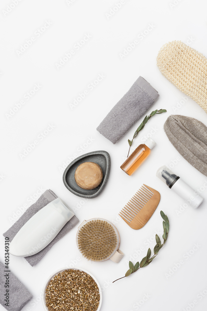 Naklejka premium Flat lay composition with bath accessories with bottles with gel or shampoo, soap, sea salt, washcloth, wooden comb