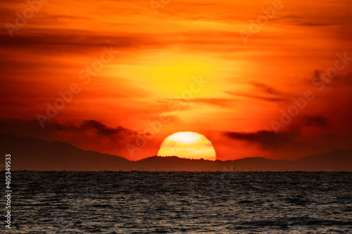 Beautiful of sunrise over the mountain and sea. © chirawan_nt