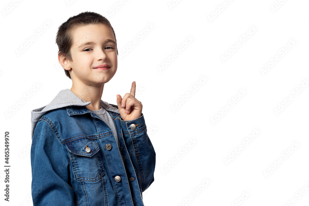 Portrait of smiling boy in denim jacket pointing up and looking at the same place, having fun on white isolated background Portrait of smiling boy in denim jacket pointing up and looking at the same place, having fun on white isolated background