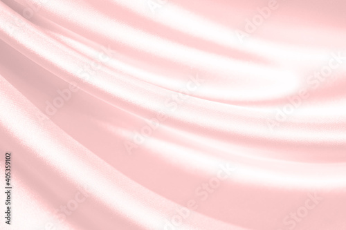 Pink silk satin background. Soft wavy folds on the fabric. Wedding, anniversary, valentine, love, tender, holiday, celebration, card. Beautiful pink abstract background with copy space for your design