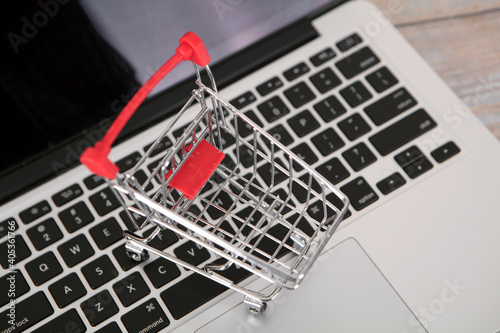 Shopping cart model on laptop keyboard