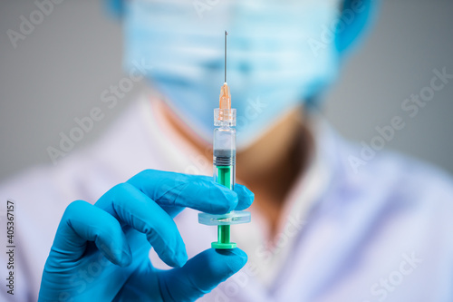 doctor holding syringe with Coronavirus (Covid-19) vaccine for injection test