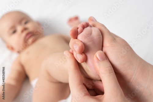 Masseur giving foot massage to baby. Selective focus