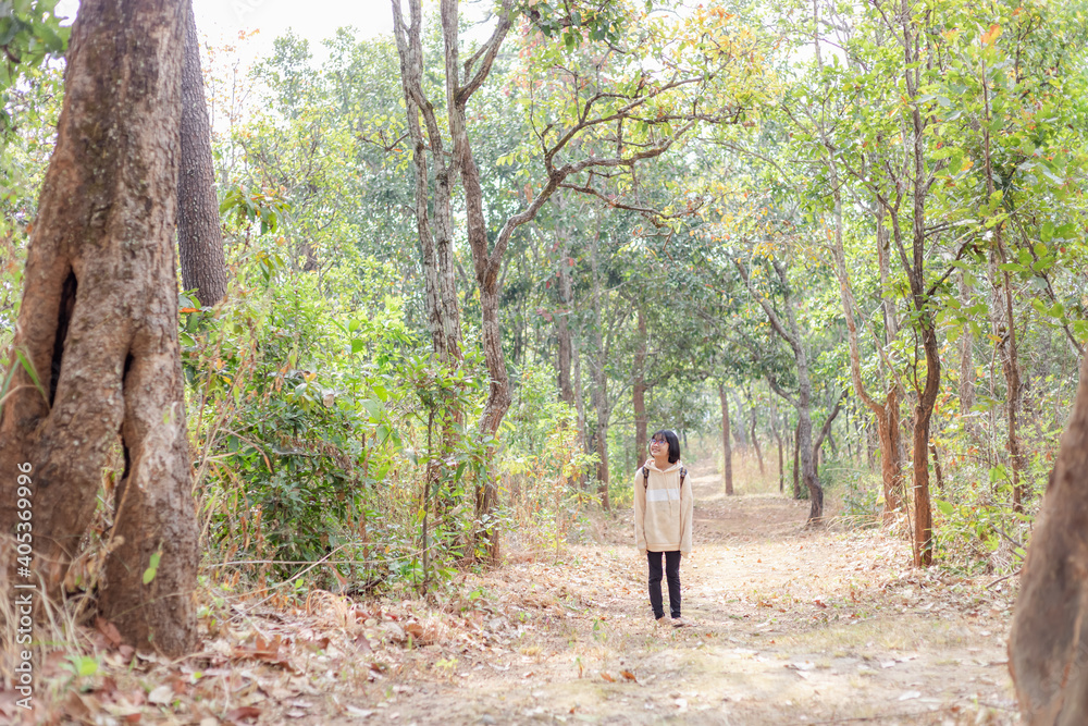 Child with backpack walking forest mountain trail Child with backpack walking forest mountain trail