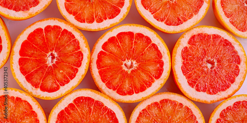 Sliced fresh  juisy vitaminous bright red  grapefruit background photo