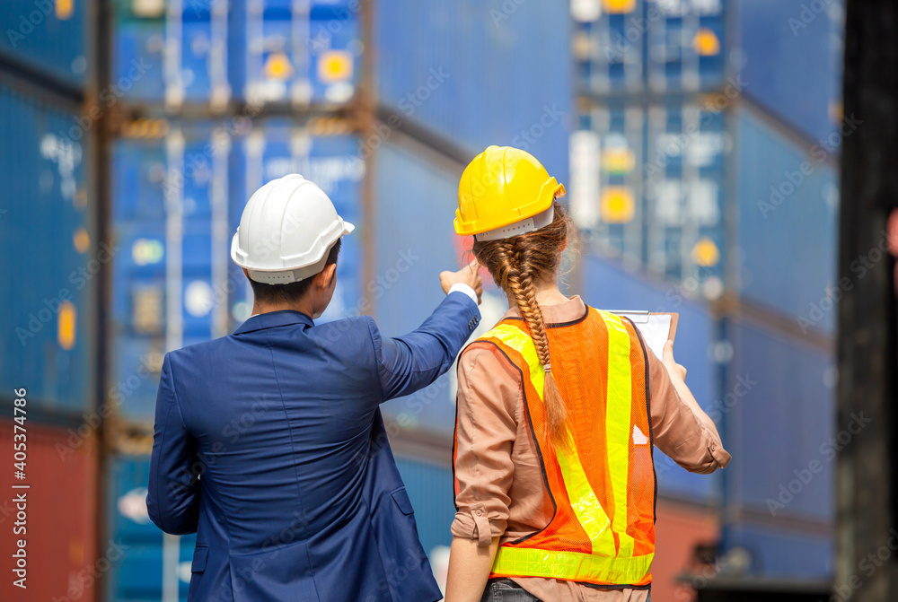 Rear view of Engineer and worker team checking containers box from cargo, Logistic and teamwork concept Rear view of Engineer and worker team checking containers box from cargo, Logistic and teamwork concept