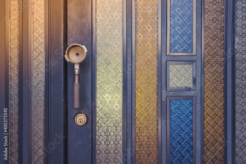 An old coffee brass measuring spoon make as a handle for open and close a door at the coffee shop.