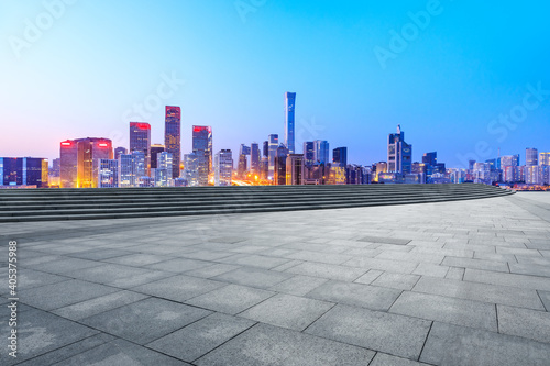 Empty square floor and modern city commercial buildings in Beijing at night,China. © ABCDstock