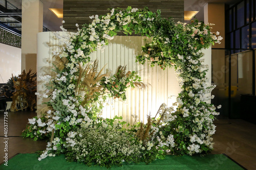Beautiful photo booth zone at wedding or birthday reception. holiday photobooth decor with flowers, and lights