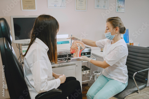 Woman patient in the medical office. Doctor in medical mask.