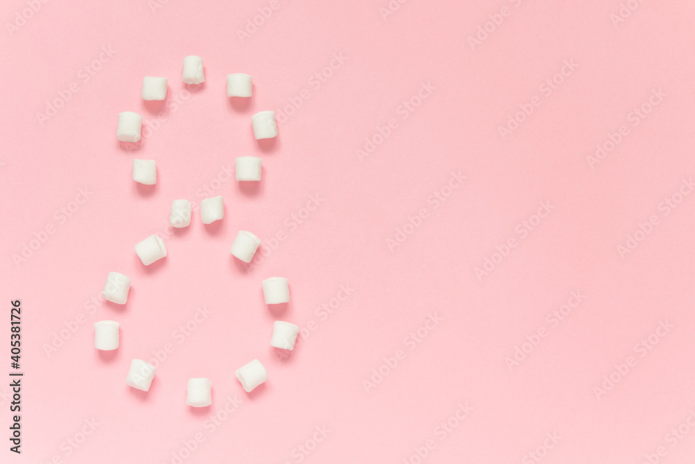 Marshmallow is laid out in the shape of number Eight on a pink background. Concept of love, happy valentine's day, women's day and birthday celebration. Flatly, copy space, mock up, banner.